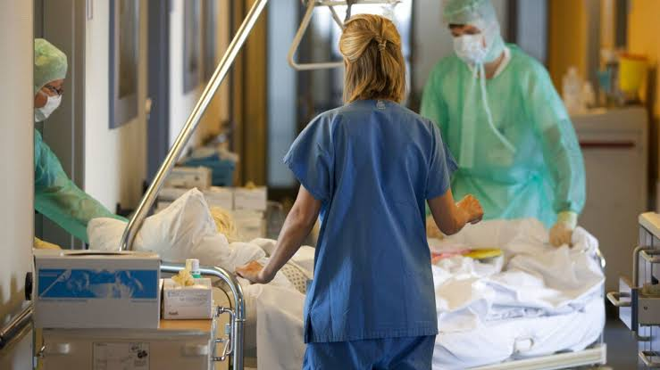 Doctors and nurses in a hospital representing the projected global shortage of 11.1 million health workers
